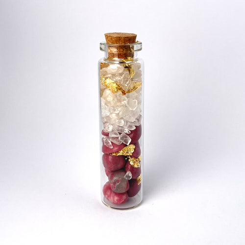 CLEAR QUARTZ WITH THULITE AND GOLD IN BOTTLE